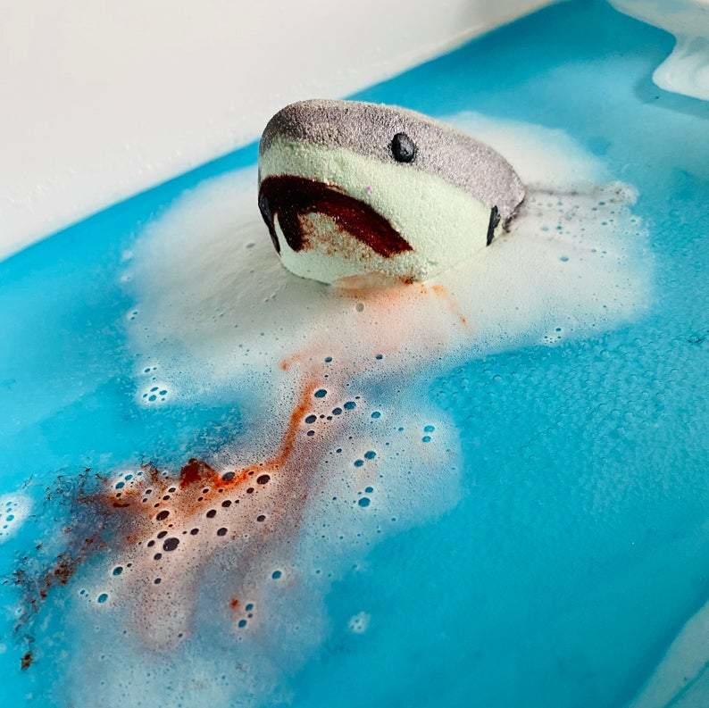 Shark attack bath bomb That gives off a jaws look as it has red bath bomb bleeding from the shark bath bombs mouth