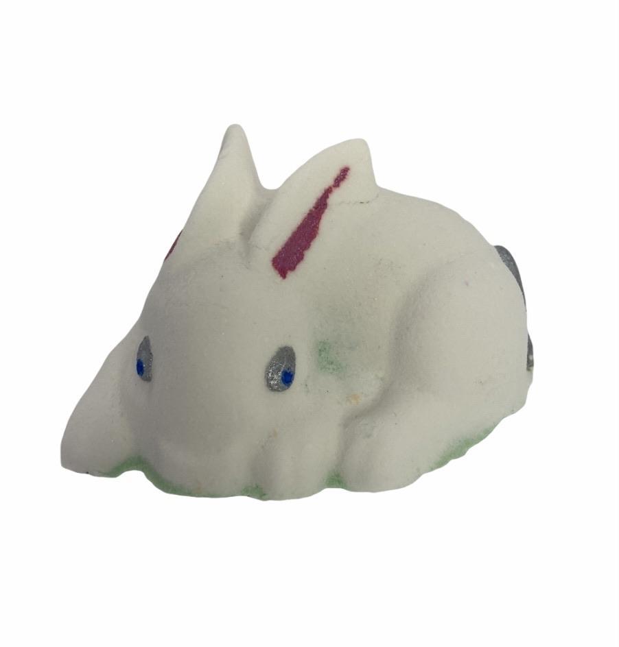 A cute white bunny bath bomb facing towards the camera.