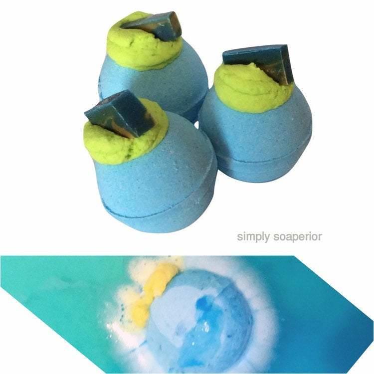 A split image of 3 Blue Man bath bombs, including a sparkling blue embed. The second split displays the bath bomb in action.