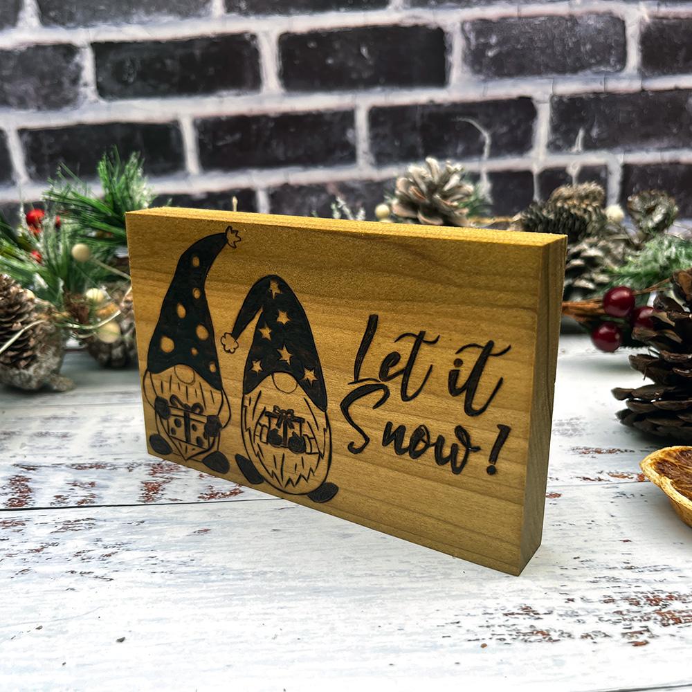 Christmas gnomes in hats and text let it snow on wooden block