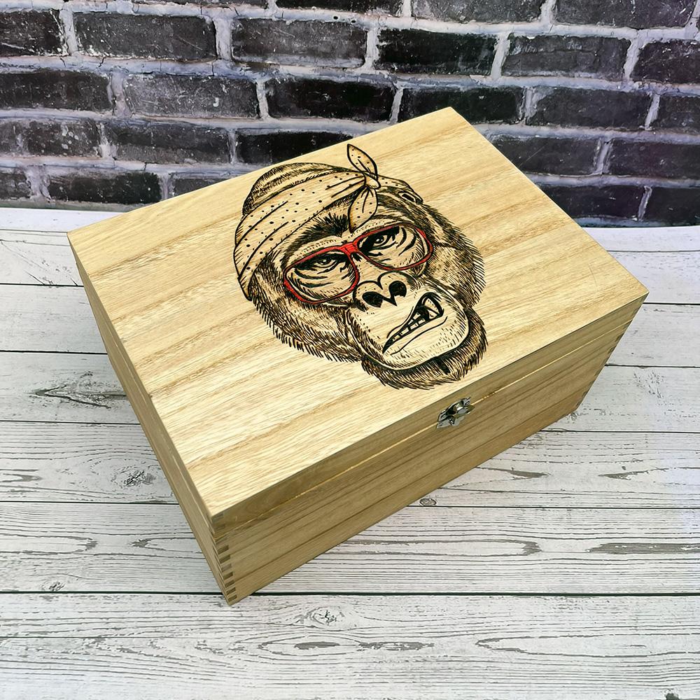 Gorilla in red sunglasses on a wood box