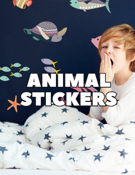 Animal wall stickers for kids, ocean theme wall stickers on a navy bedroom wall with child in bed yawning