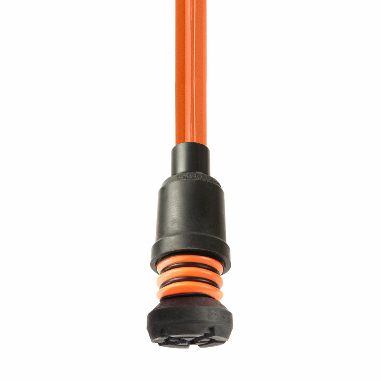 An orange Flexyfoot Comfort Grip Double Adjustable Crutch tipped with a Flexyfoot ferrule