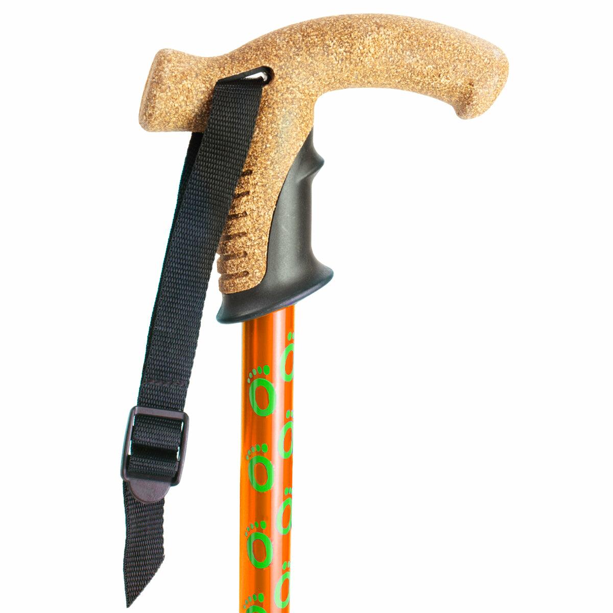The cork handle of an orange Flexyfoot Premium Cork Handle Walking Stick