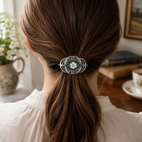 Pewter Celtic flower hair bobble securing a ponytail in brunette hair, handcrafted British hair accessory with green enamel detail