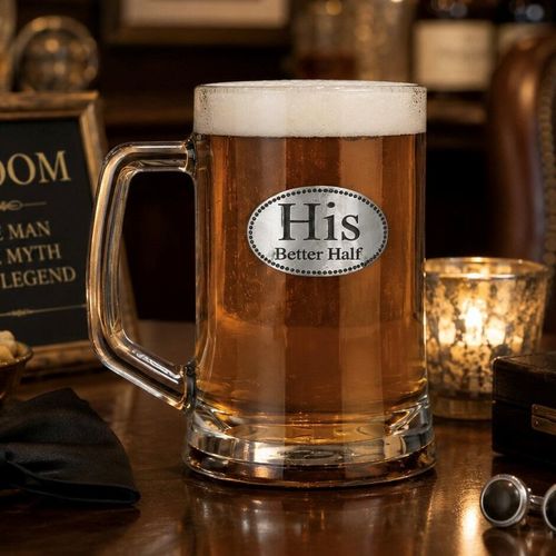 A Beer Tankard with a Pewter His badge on the front, filled with Amber Beer