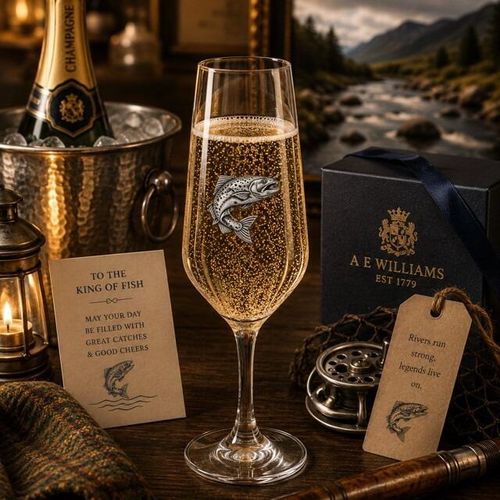 A Champagne Flute with a Pewter Salmon badge on the front, filled with Champagne
