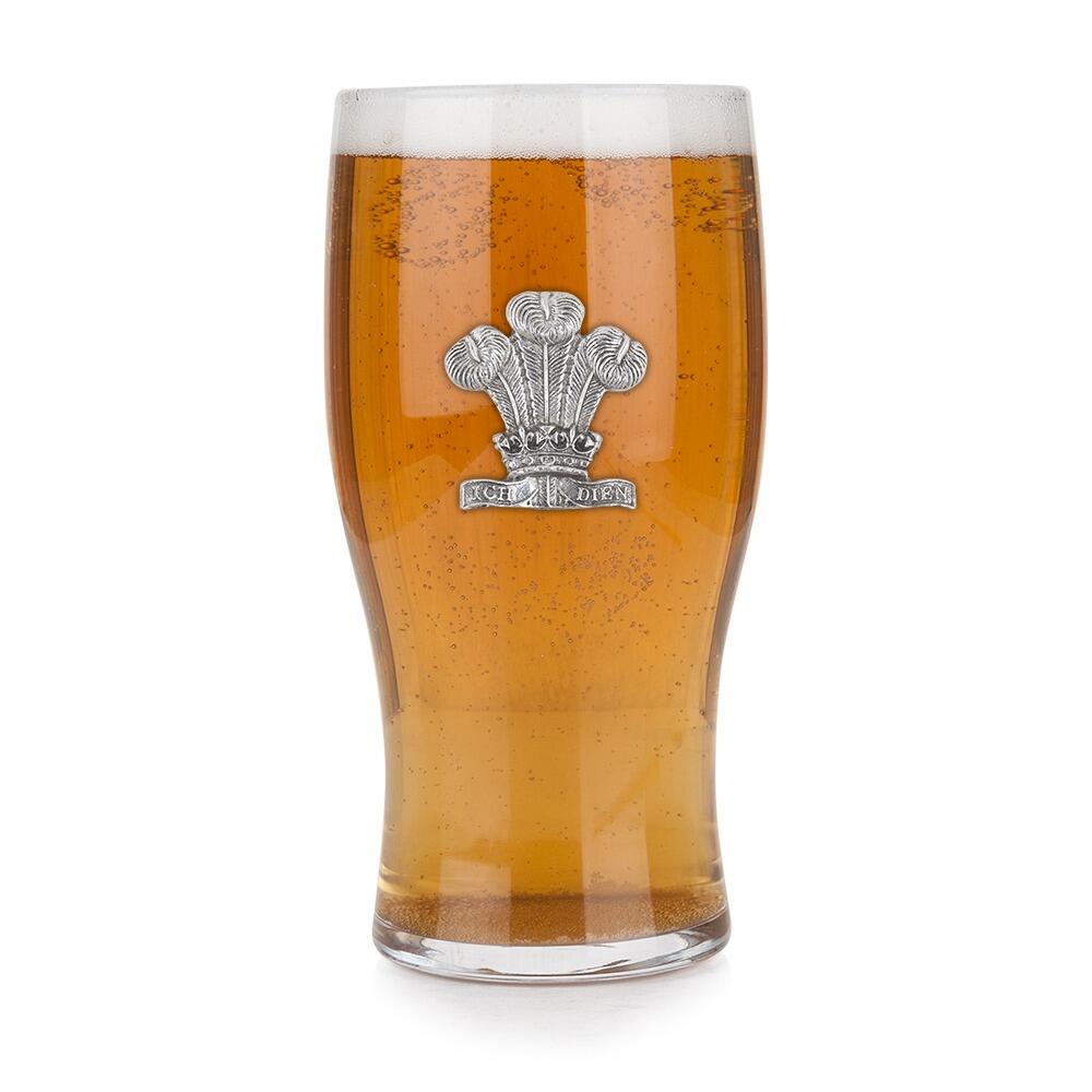 Pint glass featuring handmade pewter Welsh Feathers badge, filled with golden beer