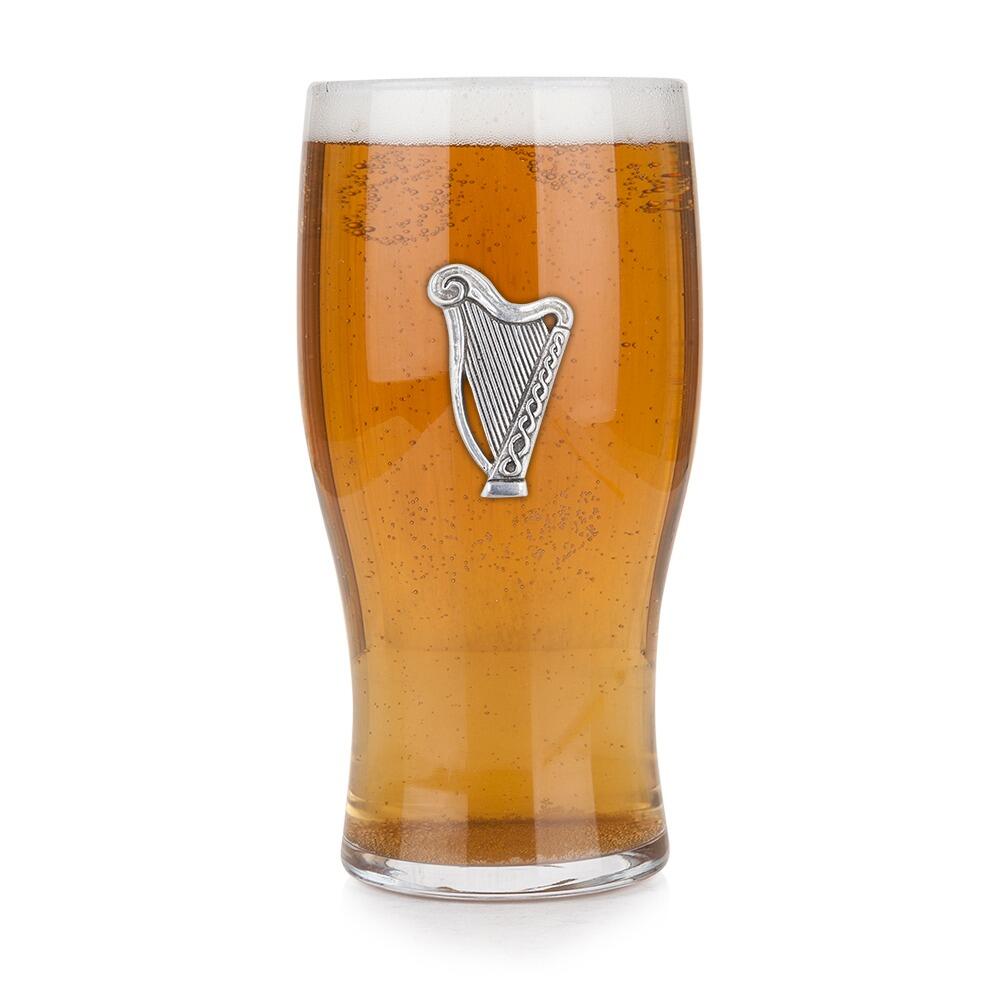 Pint glass with handmade pewter harp badge, filled with golden beer