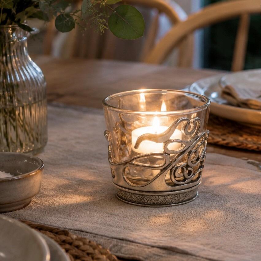 Pewter Art Nouveau tealight holder with openwork whiplash curves and a glass votive insert