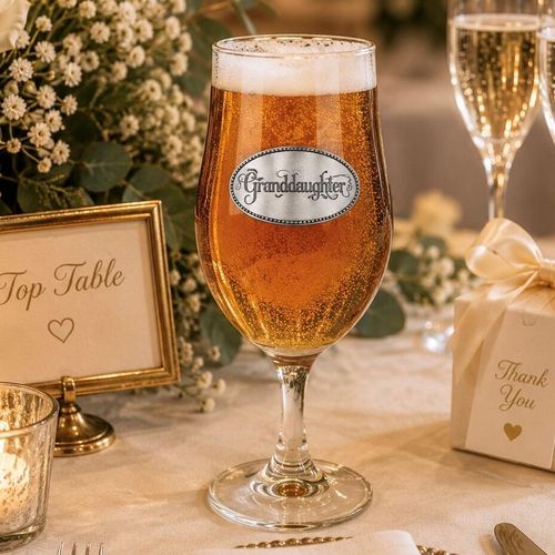 A Stemmed Pint Beer Glass with a Pewter Granddaughter badge on the front, filled with Beer