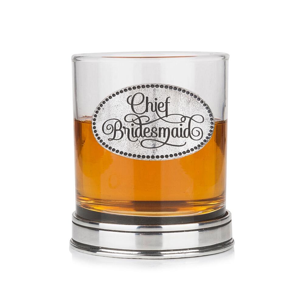 Whisky tumbler with pewter 'Chief Bridesmaid' badge and polished base, partially filled with amber liquid