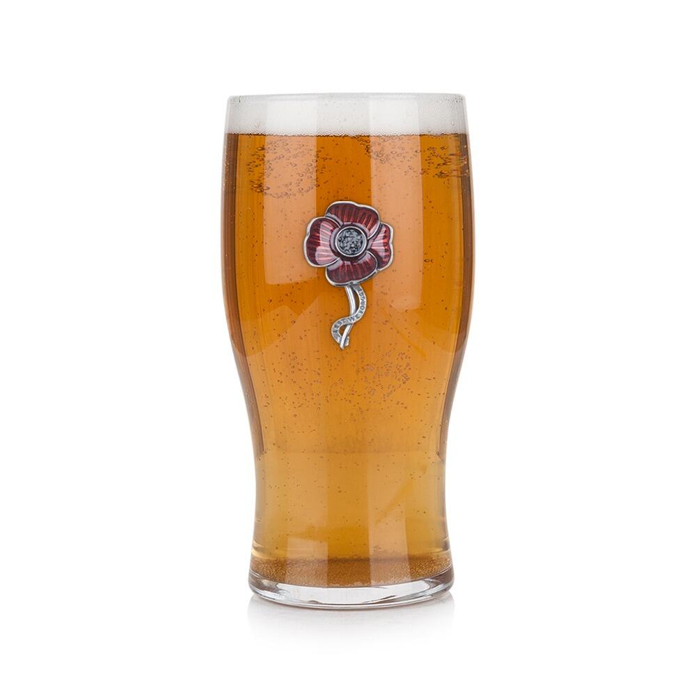 Pint glass with handmade pewter poppy badge featuring delicate petal detailing filled with golden beer
