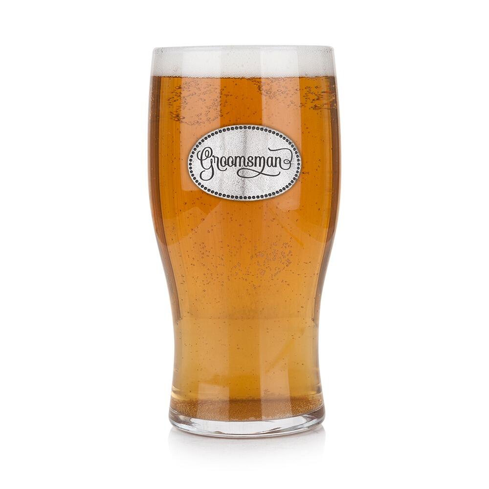 Pint glass with handmade pewter “Groomsman” badge, filled with golden beer