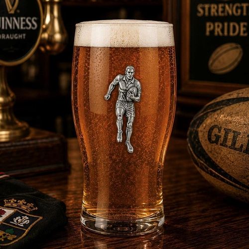 Pint glass with handmade pewter rugby player badge filled with golden beer
