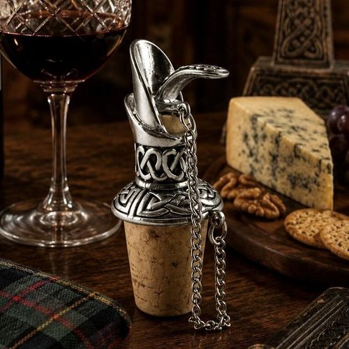 Pewter wine pourer and cork stopper featuring intricate Celtic knotwork designs