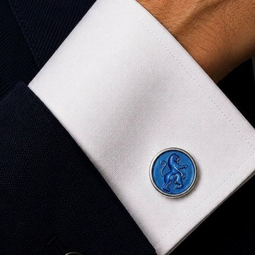 Handcrafted pewter cufflinks with a detailed rampant lion embossed in transparent blue enamel