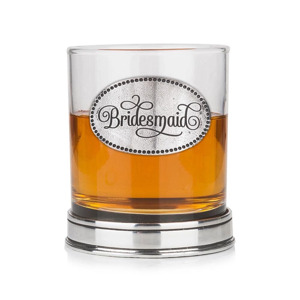 Whisky tumbler with pewter 'Bridesmaid' badge and polished base, partially filled with amber liquid