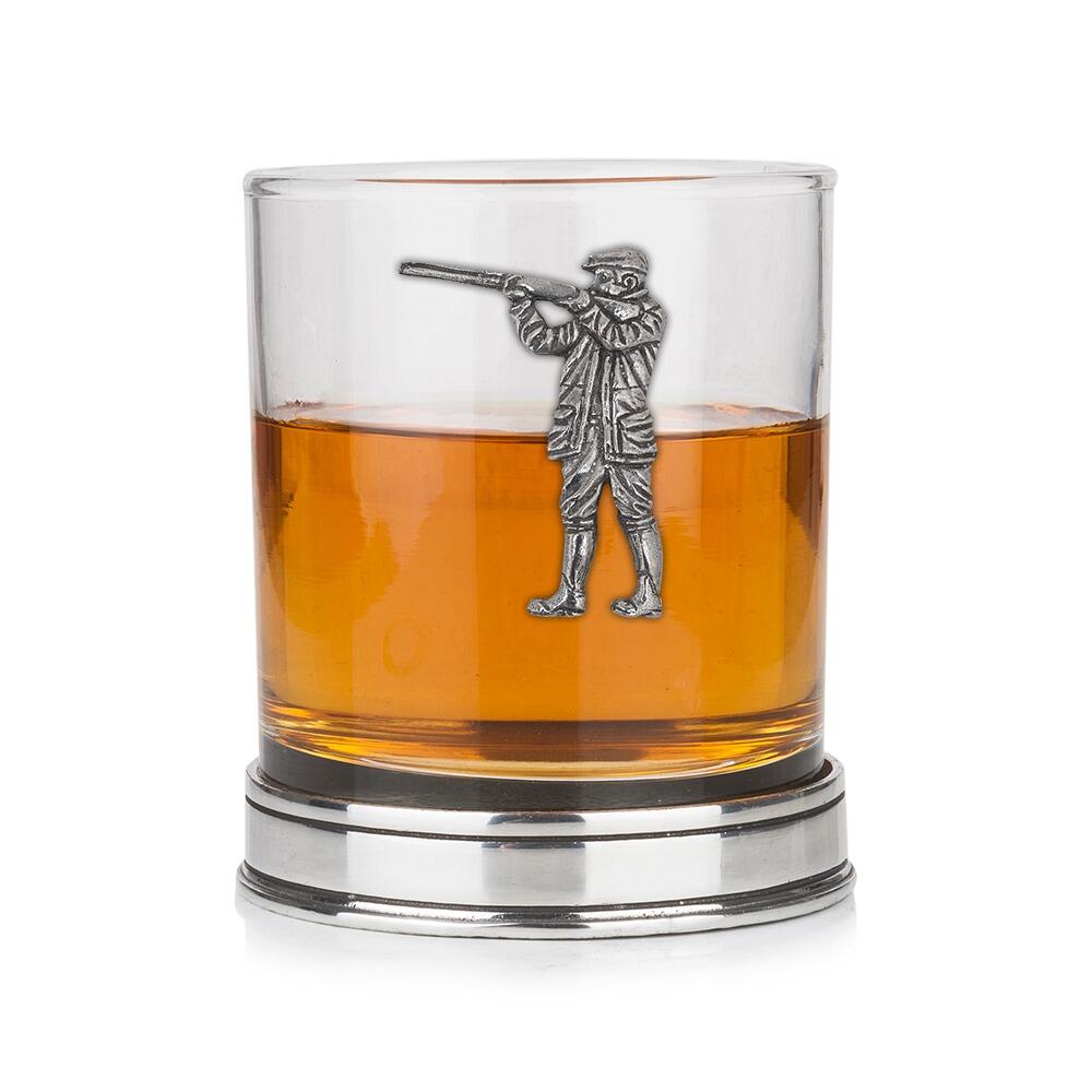 Whisky tumbler with pewter shooting motif and polished base, partially filled with amber liquid
