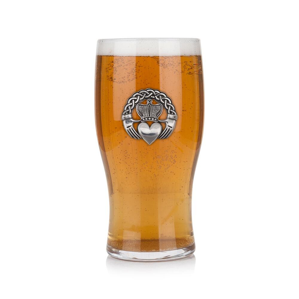 Pint glass with handmade pewter Irish Claddagh badge, filled with golden beer