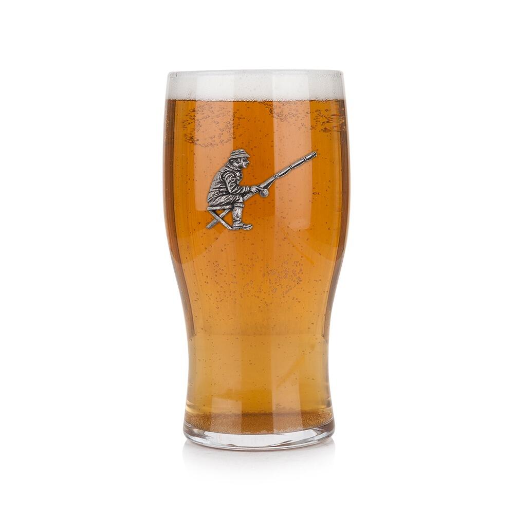 Pint glass with handmade pewter fishing badge, filled with golden beer