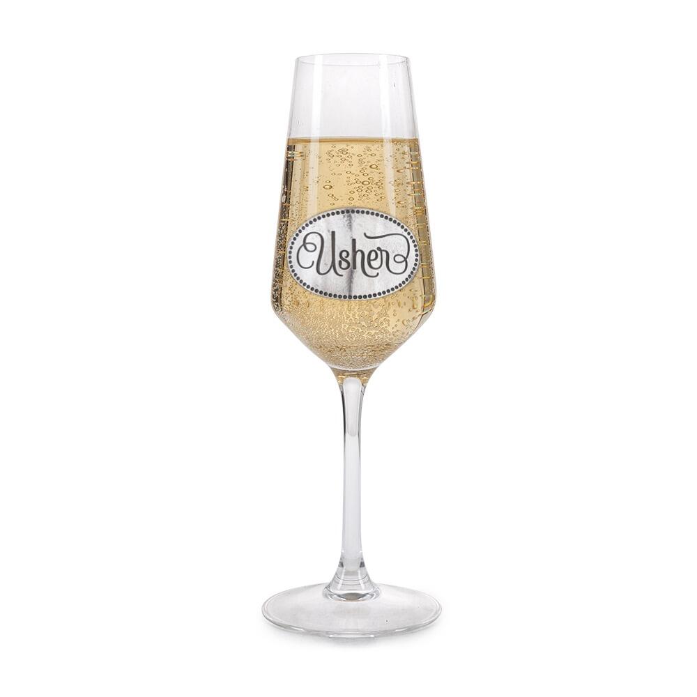 A Champagne Flute with a Pewter Usher badge on the front, filled with Champagne