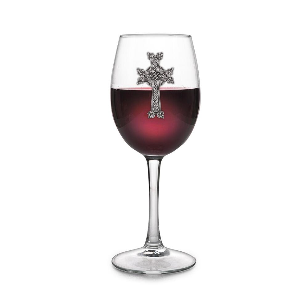 Wine glass with handcrafted pewter Cross badge filled with red wine