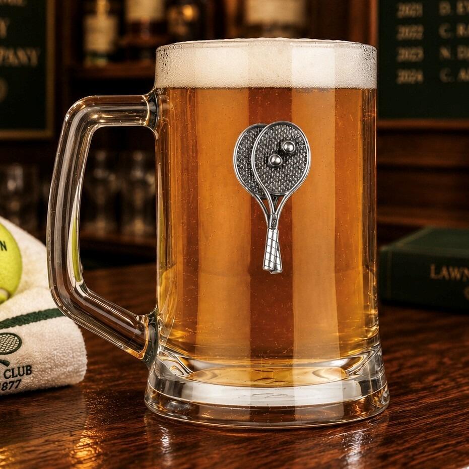 A Beer Tankard with a Pewter Tennis badge on the front, filled with Amber Beer