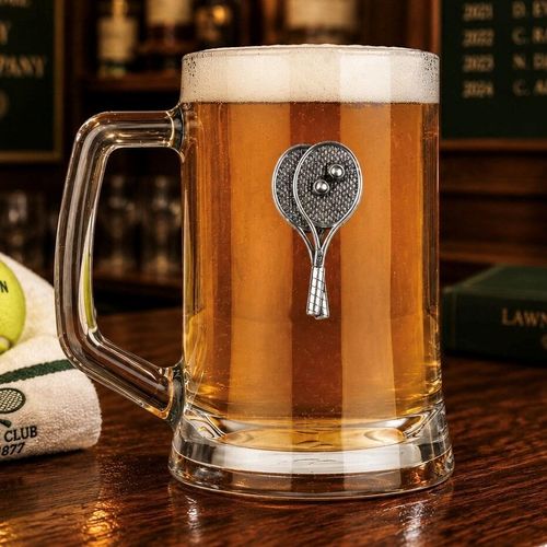 A Beer Tankard with a Pewter Tennis badge on the front, filled with Amber Beer