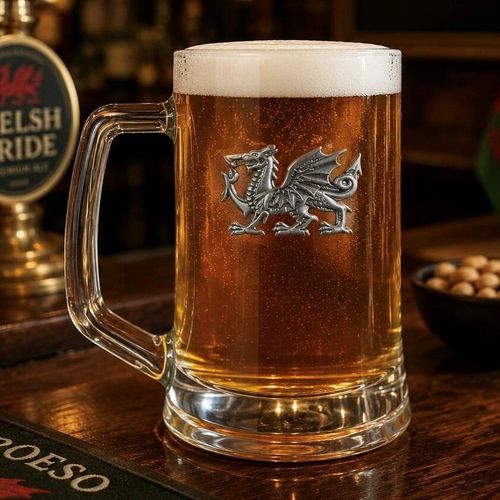 A Beer Tankard with a Pewter Welsh Dragon badge on the front, filled with Amber Beer