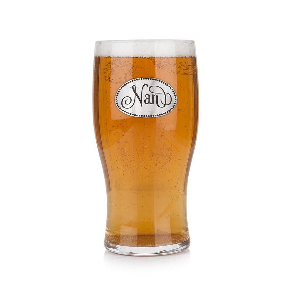 Pint glass with handmade pewter “Nan” badge, filled with golden beer
