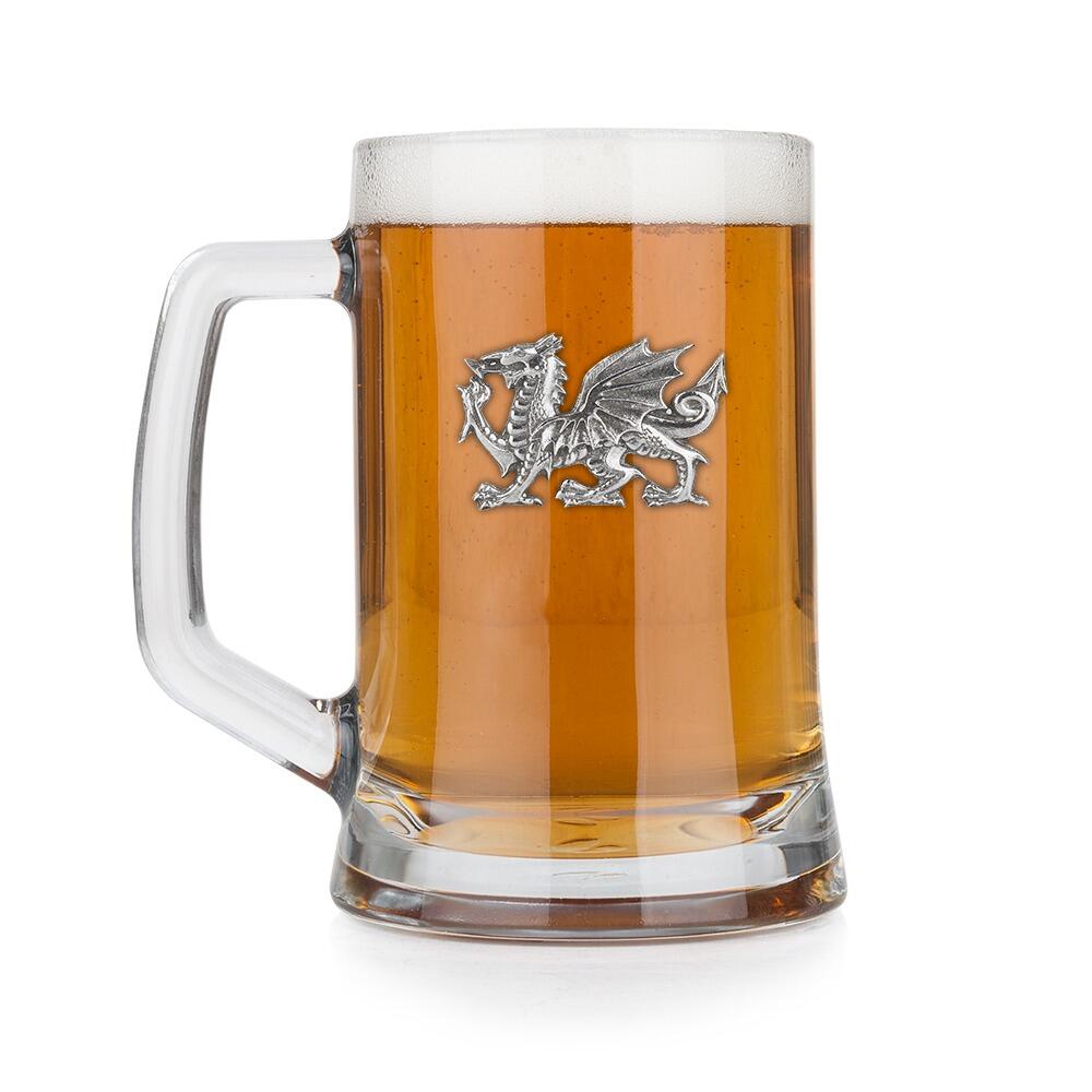 A Beer Tankard with a Pewter Welsh Dragon badge on the front, filled with Amber BeerRetryClaude can make mistakes. Please double-check responses.