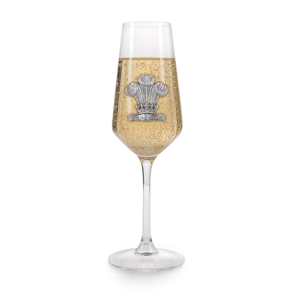 A Champagne Flute with a Pewter Welsh Feathers badge on the front, filled with Champagne