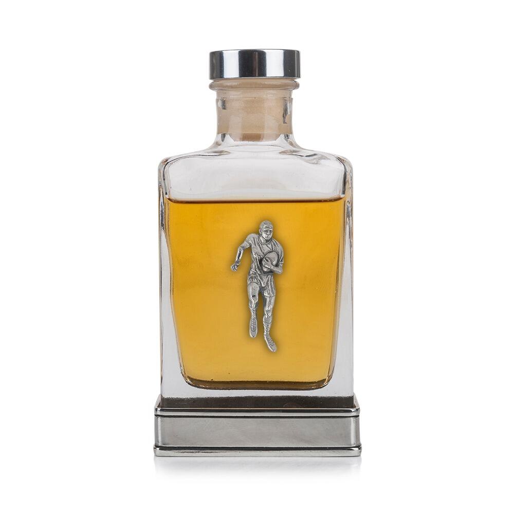 A glass flask with a pewter base and a handcrafted pewter rugby emblem on the front
