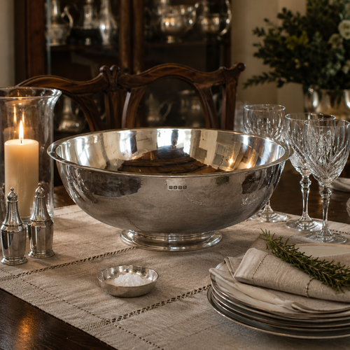 Handcrafted pewter 14 inch footed bowl with polished hammered finish, luxury dining table centrepiece displayed with crystal stemware, candlelit décor and traditional table settings