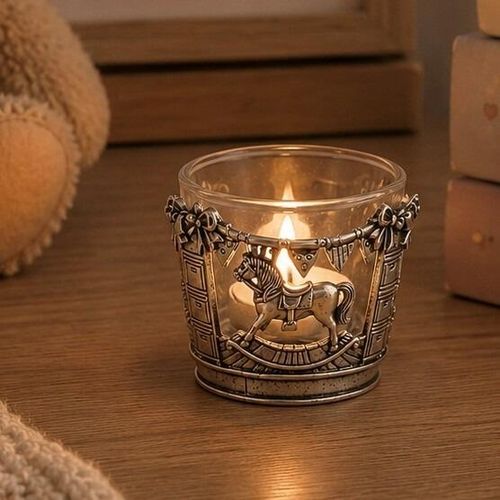 Pewter and glass tealight candle holder featuring an intricate rocking horse and nursery bunting design
