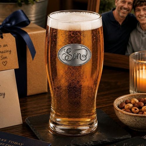 Pint glass with handmade pewter “Son” badge, filled with golden beer