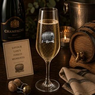 Crystal champagne flute with pewter champagne barrel emblem, filled with bubbly champagne