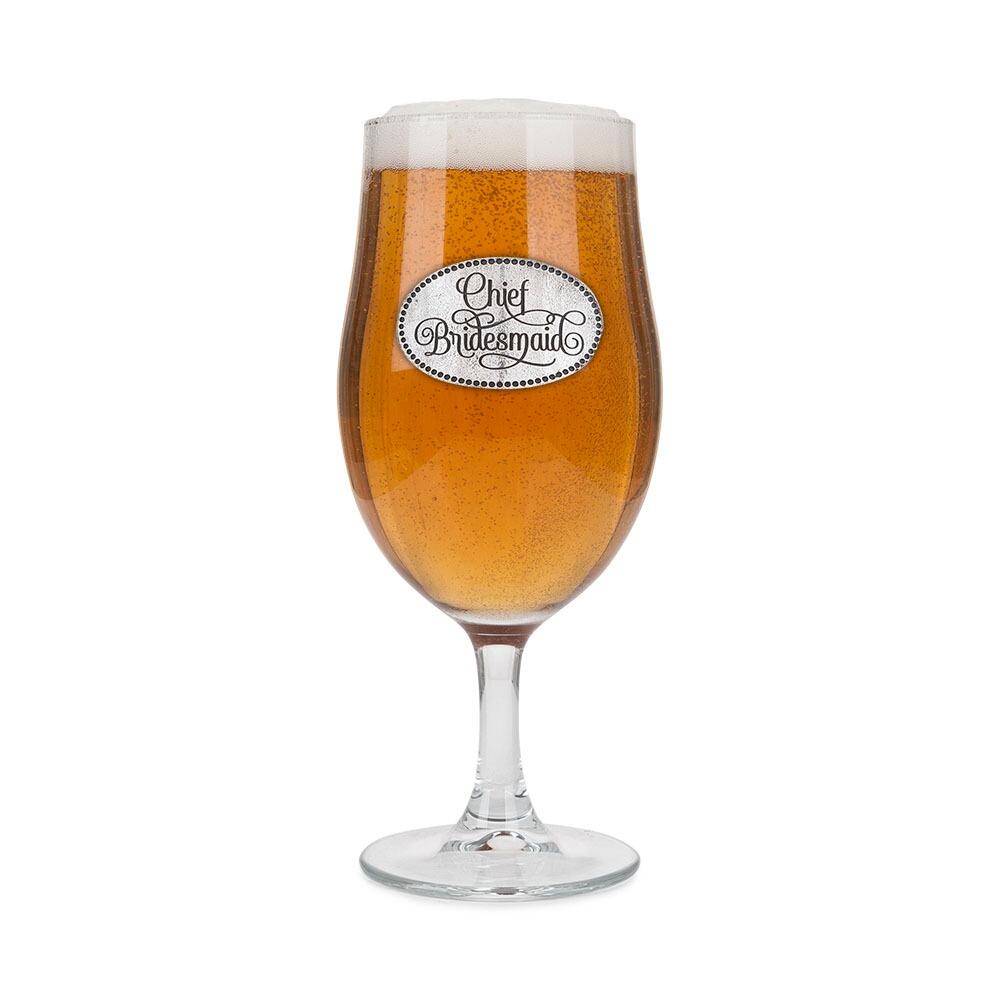 A Stemmed Pint Beer Glass with a Pewter Chief Bridesmaid badge on the front, filled with Beer