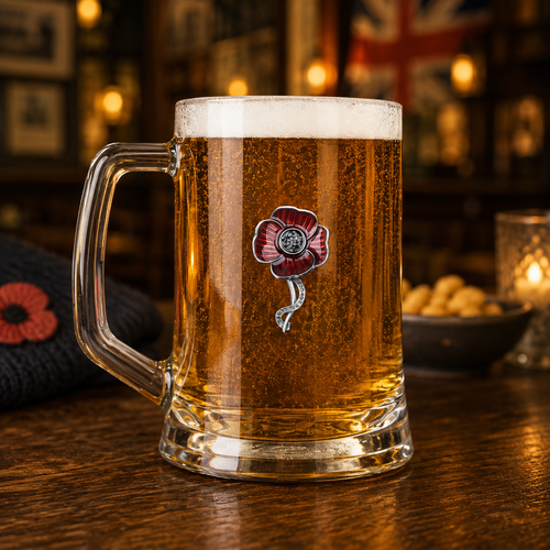 A Tankard with a Pewter Poppy badge on the front, The badge is enamelled in a red colour, the tankard filled with Beer.