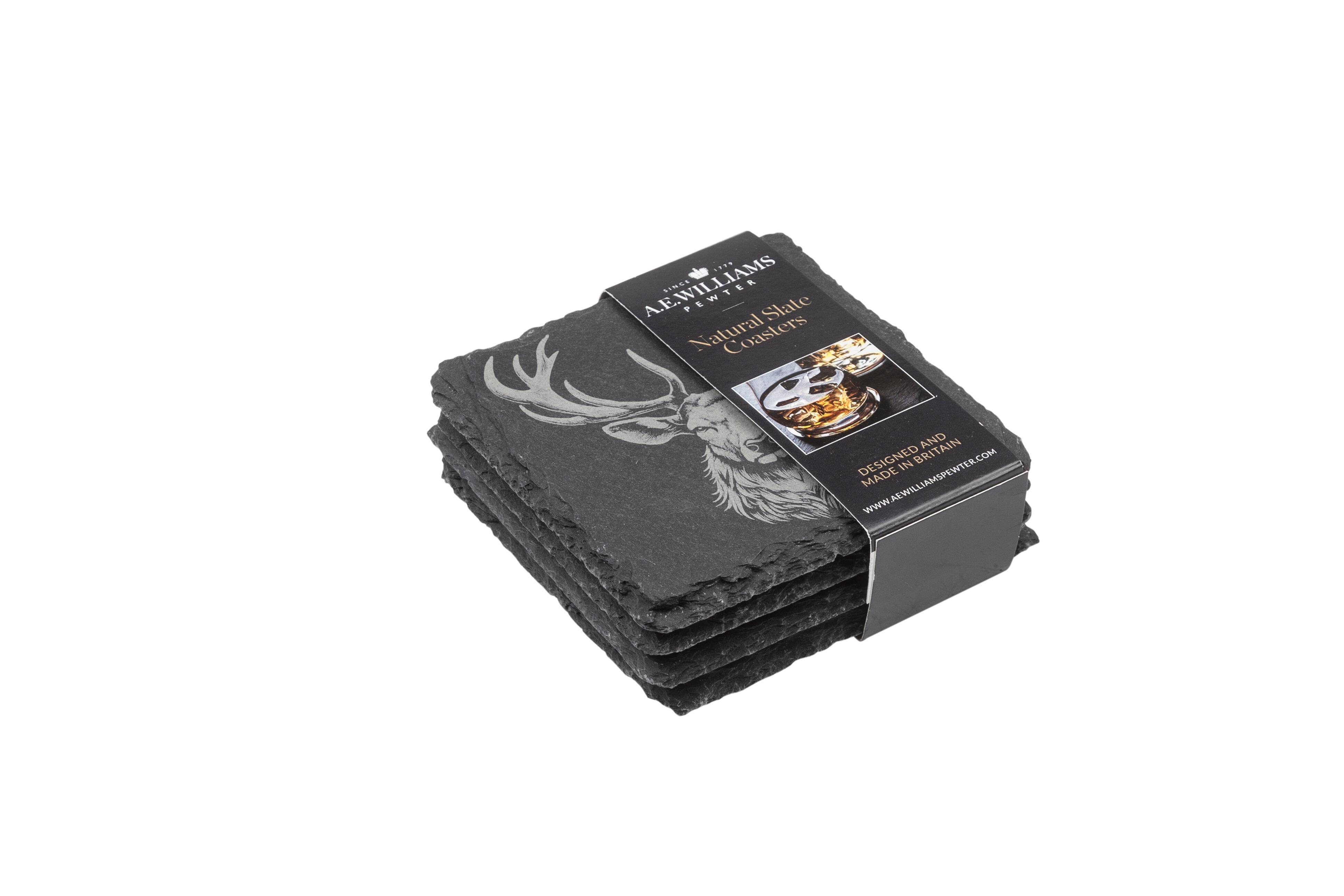 The top coaster features an engraved Stag design. A product label wraps around the stack, displaying the brand name, product type 'Natural Slate Coasters', and an image of a Stag on a coaster. The label states 'Designed and Made in Britain' and includes the company website.