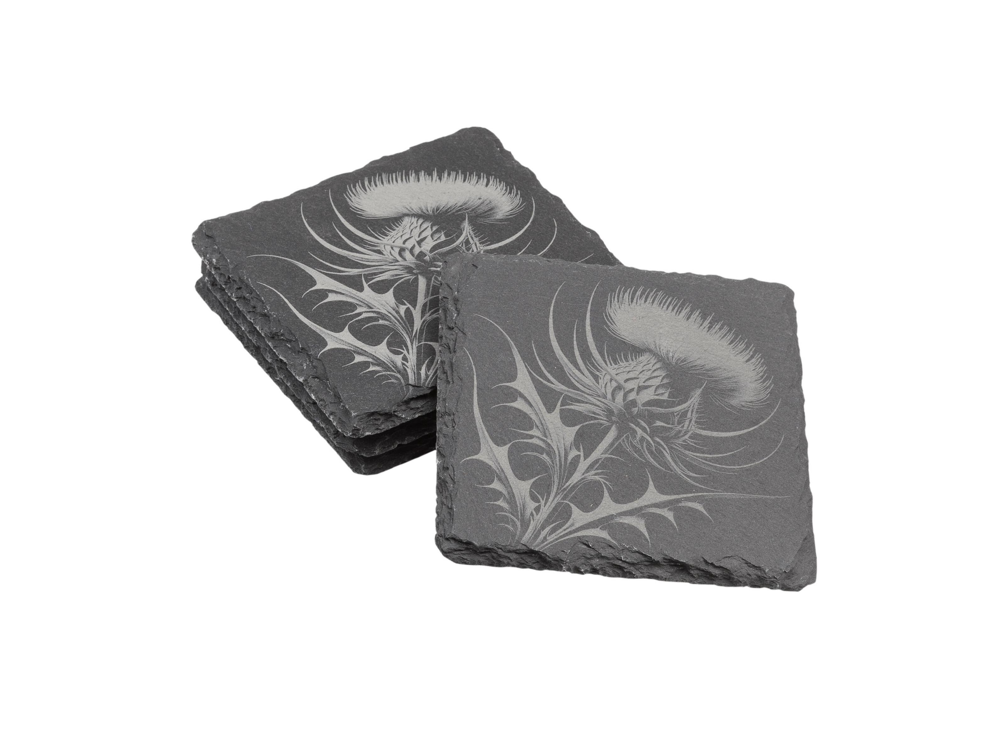 Natural slate coasters with etched thistle design displayed in stacked arrangement