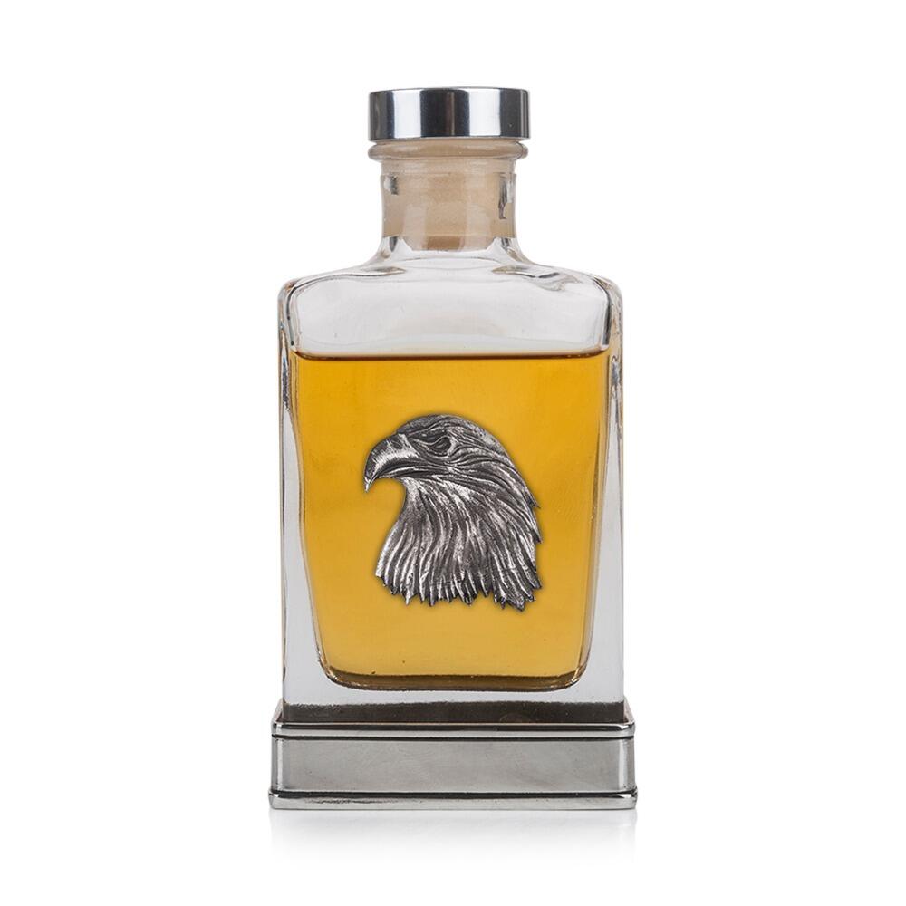 Glass whiskey flask featuring a pewter eagle head emblem and metal base