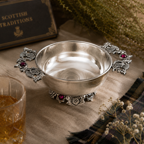 A Pewter Thistle Quaich bowl on a tablecloth