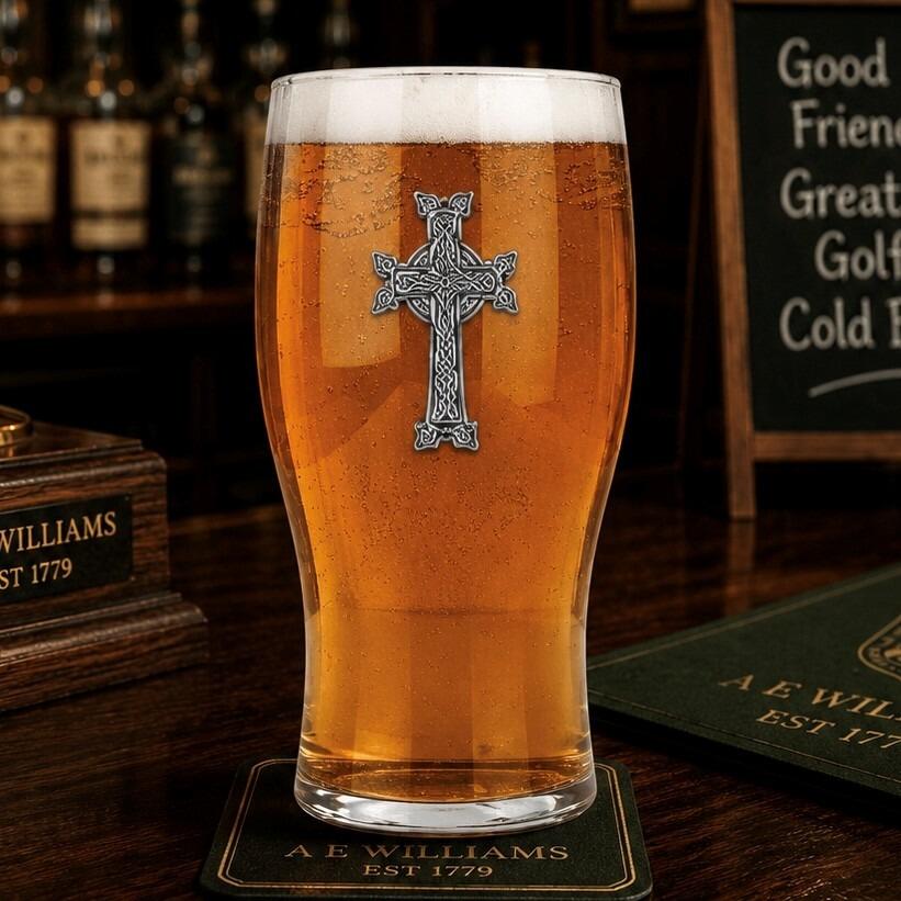 Pint glass with handmade pewter cross badge featuring sacred Christian symbol filled with golden