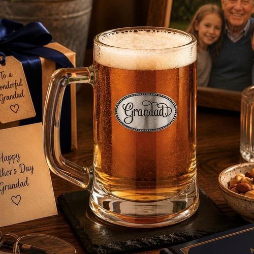 A Beer Tankard with a Pewter Grandad badge on the front, filled with Amber Beer
