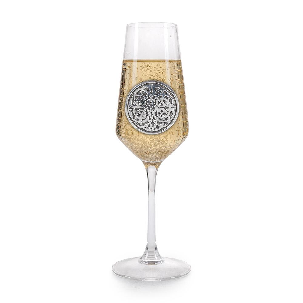 A Champagne Flute with a Pewter Never Ending Knot badge on the front, filled with Champagne