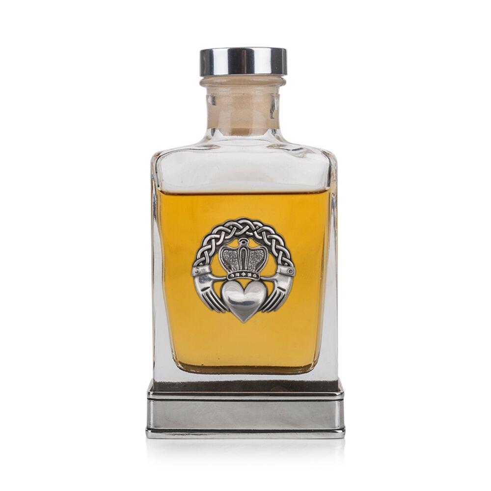 Handcrafted glass hip flask with pewter base featuring detailed Claddagh emblem on front