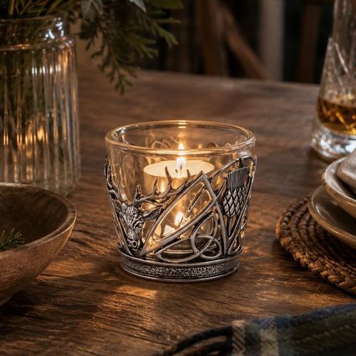 Pewter and glass tealight candle holder featuring an intricate Scottish stag head, mountain peaks, and thistle design