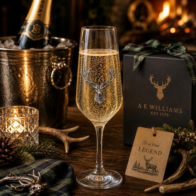 A Champagne Flute with a Pewter Stag badge on the front, filled with Champagne